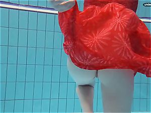 red clothed nubile swimming with her eyes opened