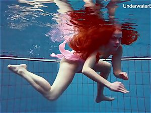 red-haired Simonna flashing her body underwater